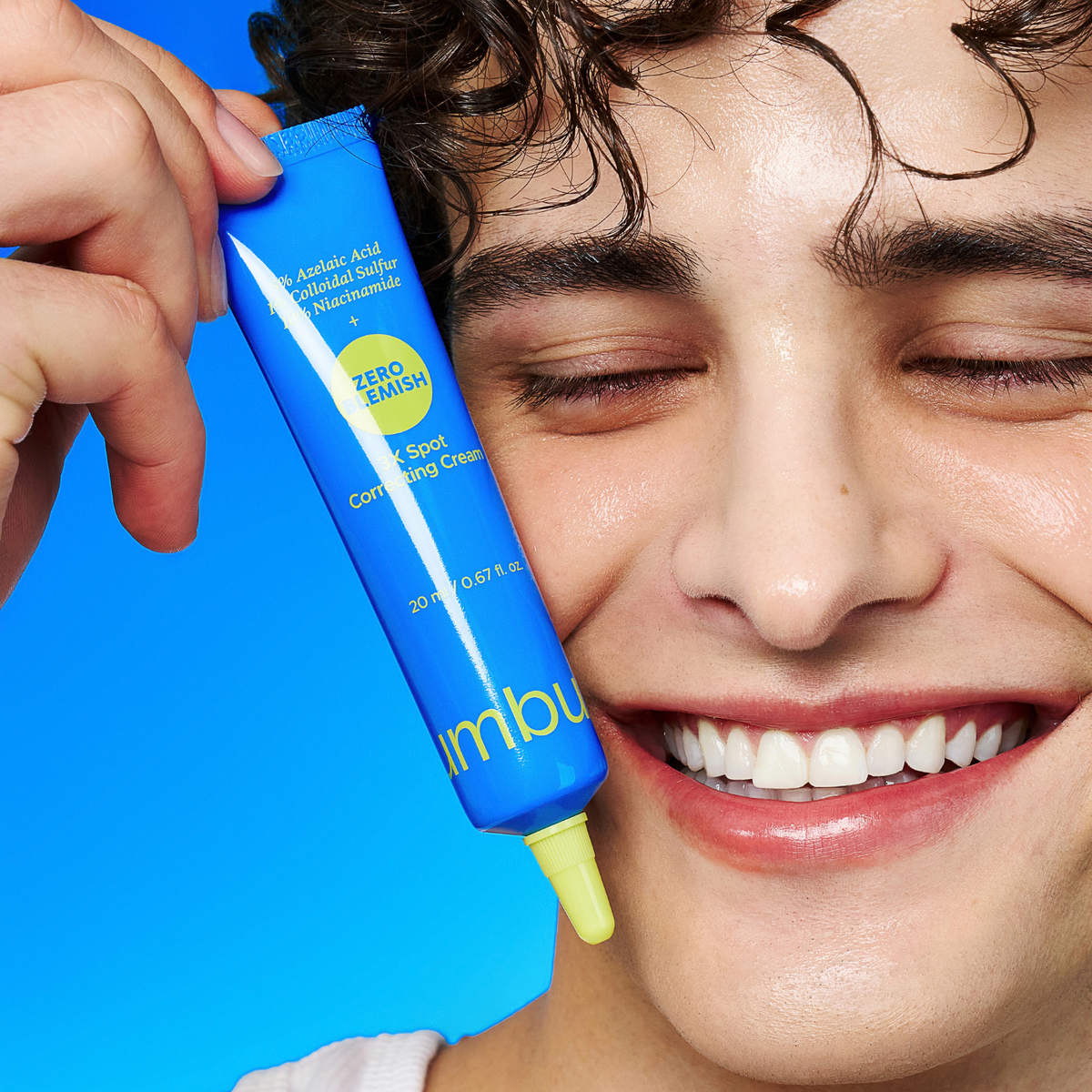 a promotional image of man holding zero blemish spot cream